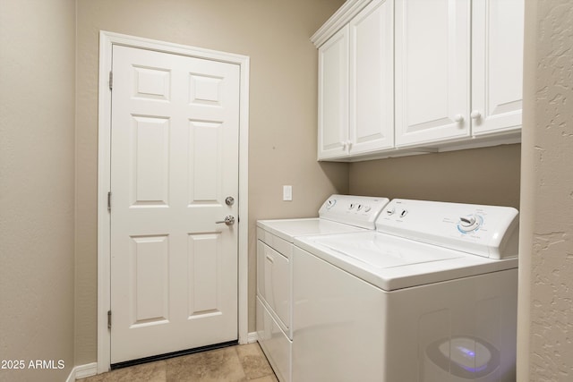 laundry room with cabinet space, washing machine and clothes dryer, and baseboards