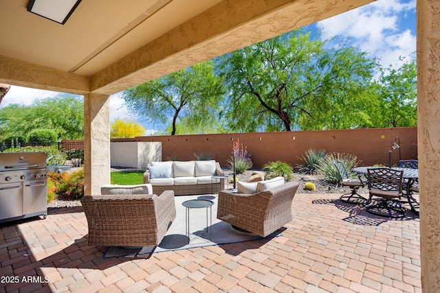 view of patio / terrace with a fenced backyard, outdoor dining area, and an outdoor hangout area