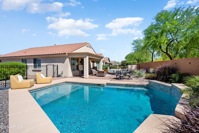 view of swimming pool featuring a fenced in pool, a patio, fence, and an outdoor hangout area