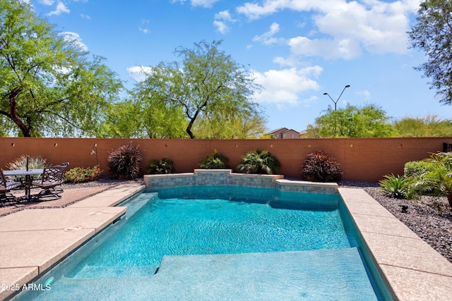 view of swimming pool featuring a fenced backyard, a fenced in pool, and a patio