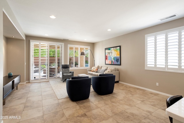 living room with recessed lighting, visible vents, and baseboards