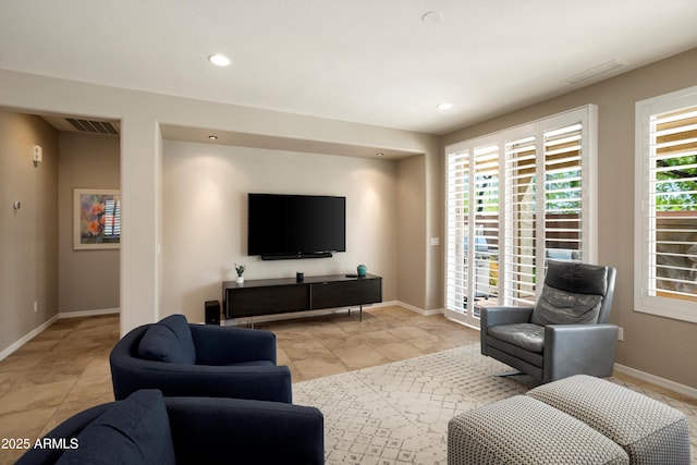 living area featuring visible vents, baseboards, and recessed lighting