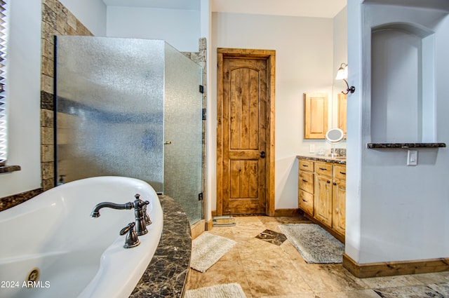 bathroom with vanity and independent shower and bath