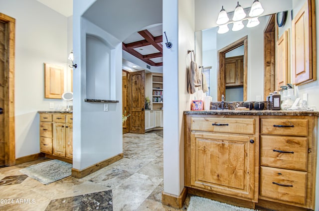 bathroom with vanity, beam ceiling, and coffered ceiling