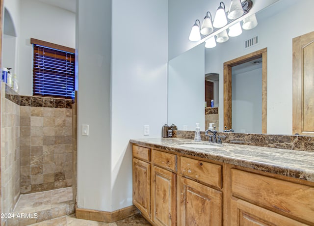 bathroom featuring vanity and a tile shower