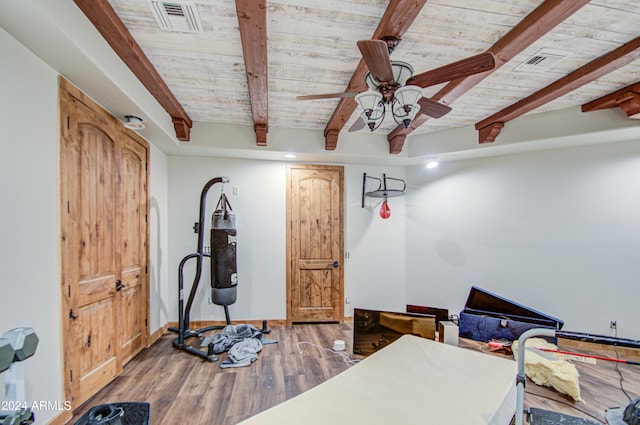 exercise room featuring hardwood / wood-style flooring, wooden ceiling, and ceiling fan