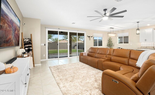 tiled living room featuring ceiling fan