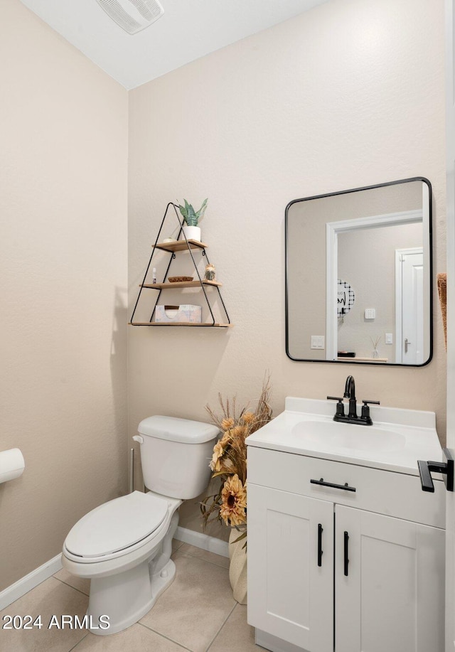 bathroom with vanity, tile patterned floors, and toilet