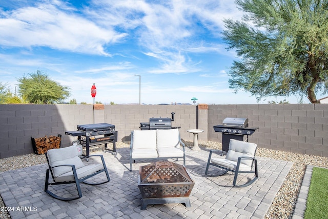 view of patio featuring area for grilling and a fire pit