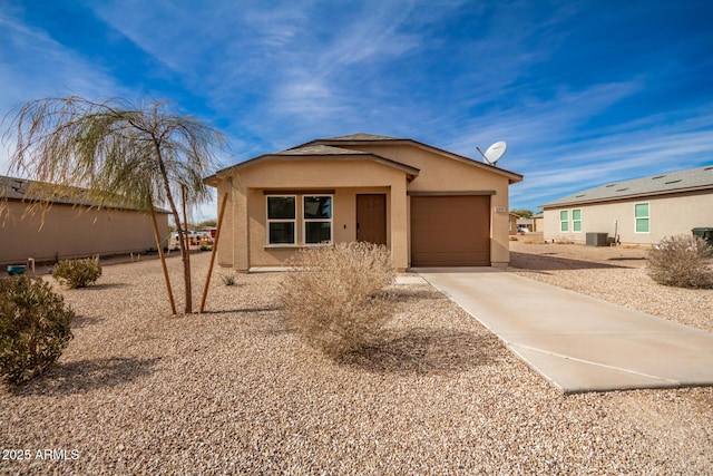 view of front of house featuring a garage and central air condition unit