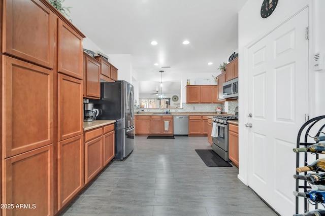 kitchen featuring pendant lighting, sink, appliances with stainless steel finishes, dark hardwood / wood-style floors, and tasteful backsplash