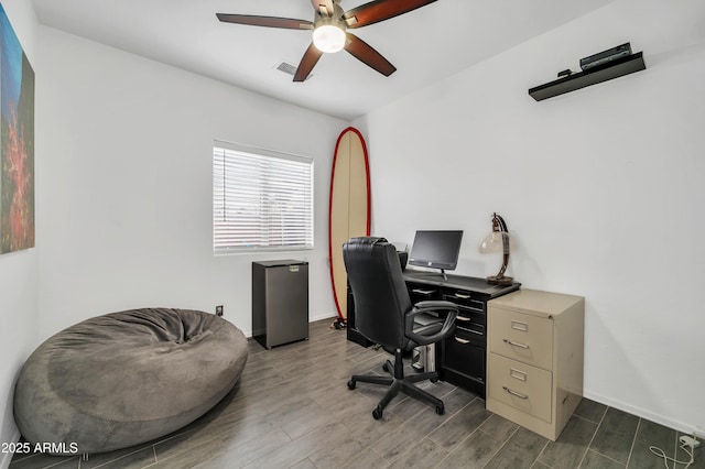 office featuring dark hardwood / wood-style floors and ceiling fan