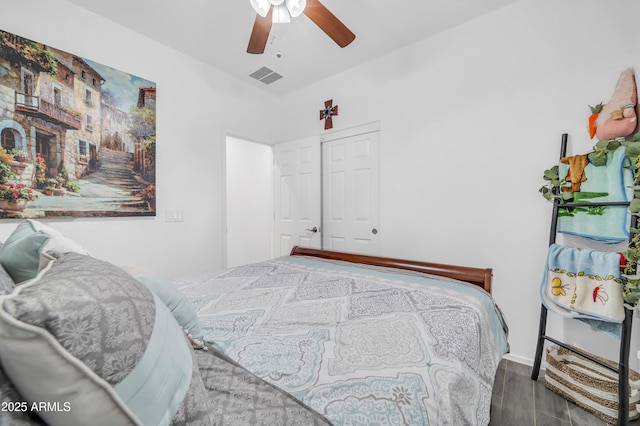 bedroom with hardwood / wood-style flooring, ceiling fan, and a closet