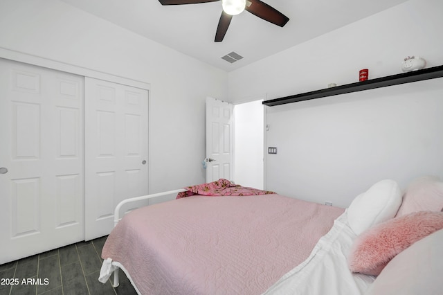 bedroom with ceiling fan and a closet