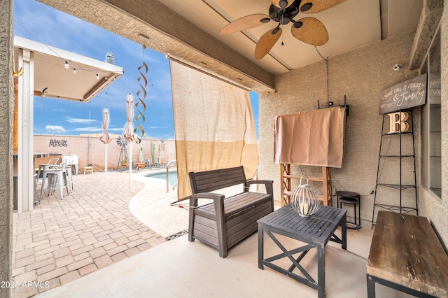 view of patio / terrace featuring a fenced in pool and ceiling fan