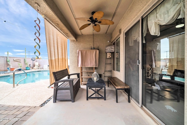 view of patio / terrace featuring ceiling fan and a fenced in pool