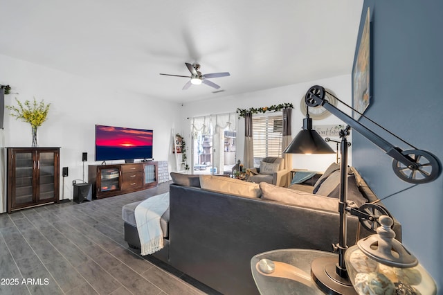 living room featuring dark wood-type flooring and ceiling fan