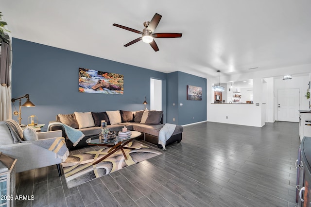 living room with dark wood-type flooring and ceiling fan