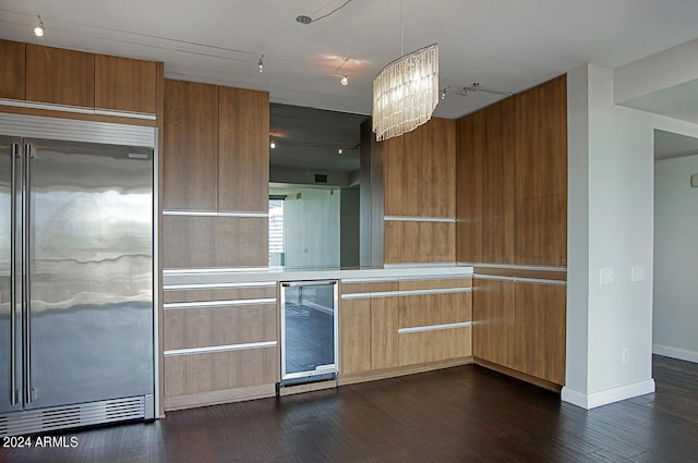 kitchen with built in fridge, dark hardwood / wood-style floors, wine cooler, and a chandelier