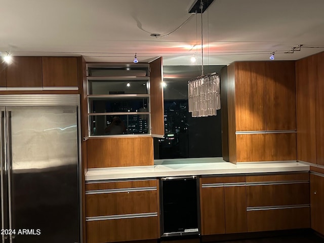 bar with track lighting and built in refrigerator