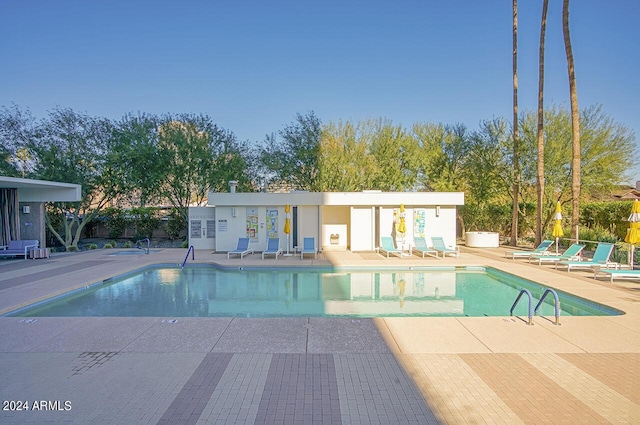 view of swimming pool with a patio