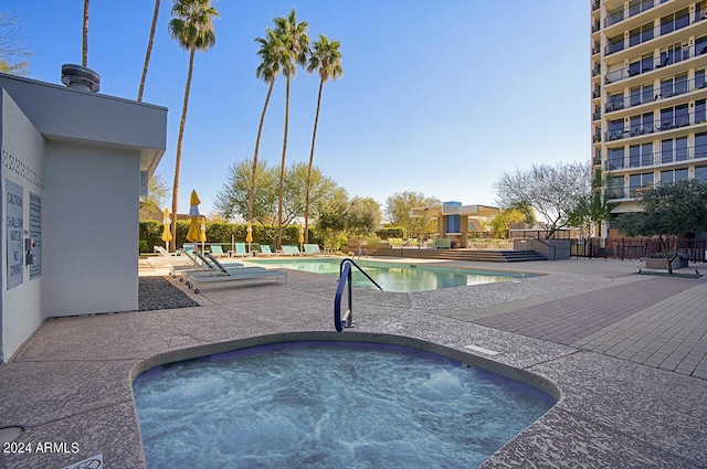 view of pool featuring a community hot tub and a patio