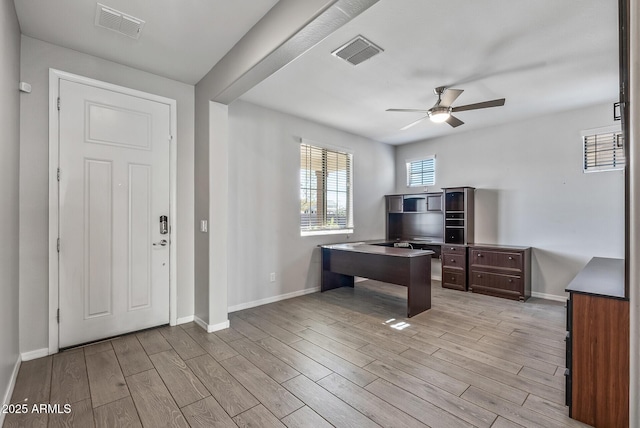 home office with ceiling fan and light hardwood / wood-style flooring