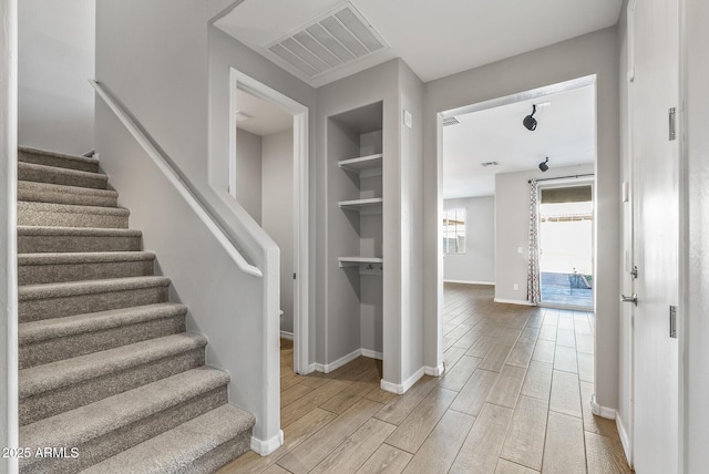 staircase with built in shelves