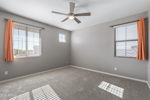 spare room with carpet flooring, ceiling fan, and plenty of natural light