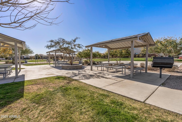 view of property's community featuring a lawn, a gazebo, and a patio