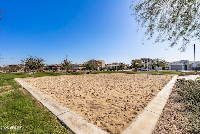 view of home's community with volleyball court and a lawn