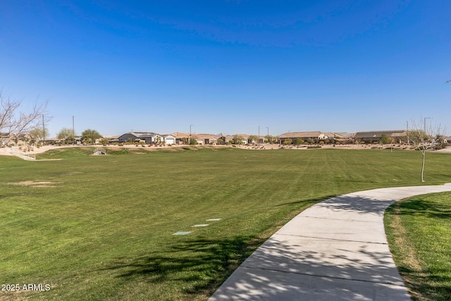 view of home's community featuring a yard