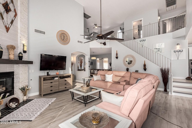 337 E Clairidge Dr, San Tan Valley, AZ 85143 - living room with stairway, visible vents, wood finished floors, and a stone fireplace