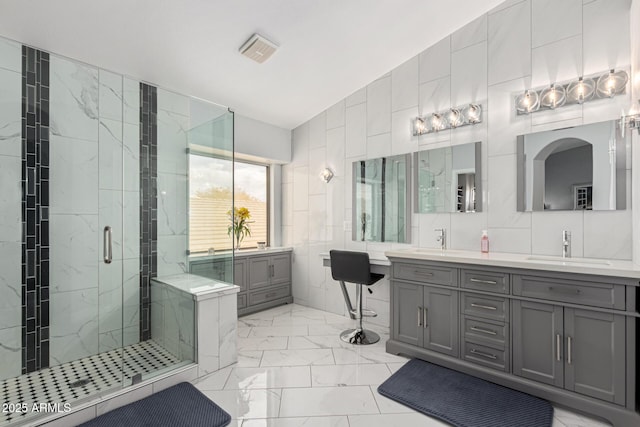337 E Clairidge Dr, San Tan Valley, AZ 85143 - bathroom featuring marble finish floor, tile walls, a marble finish shower, visible vents, and a sink