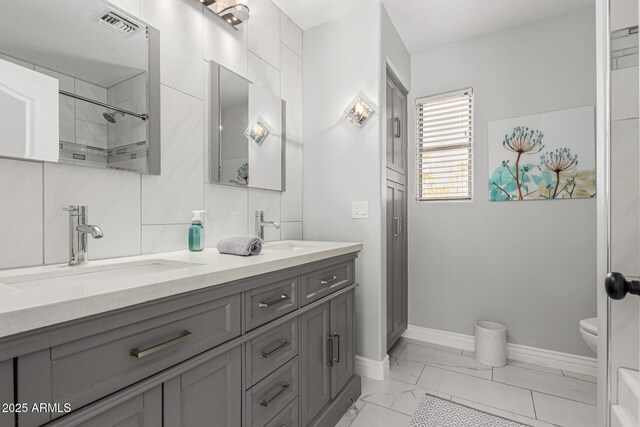 337 E Clairidge Dr, San Tan Valley, AZ 85143 - full bath featuring marble finish floor, a sink, baseboards, and double vanity