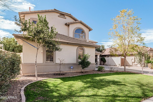 337 E Clairidge Dr, San Tan Valley, AZ 85143 - view of front of house featuring a tiled roof, a front lawn, fence, and stucco siding