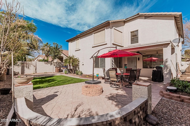 337 E Clairidge Dr, San Tan Valley, AZ 85143 - back of house with an outdoor fire pit, a ceiling fan, fence, a patio area, and stucco siding