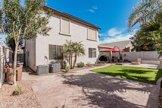 337 E Clairidge Dr, San Tan Valley, AZ 85143 - rear view of property with central AC unit, stucco siding, a fire pit, and a patio