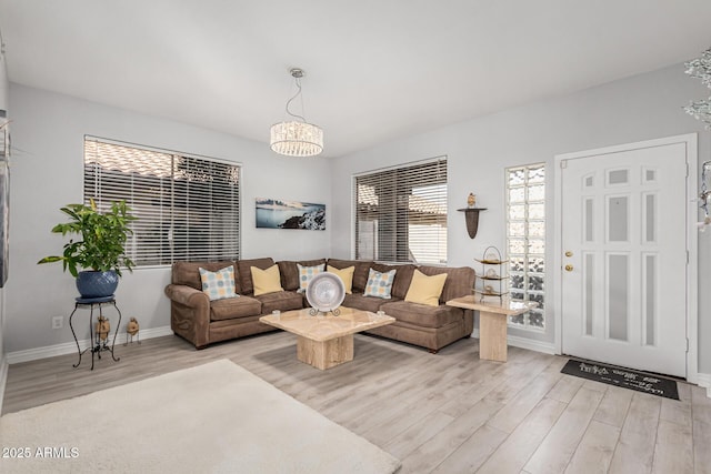 337 E Clairidge Dr, San Tan Valley, AZ 85143 - living area with a chandelier, light wood-style flooring, and baseboards