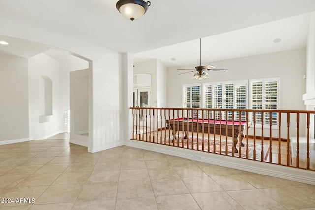 hall featuring light tile patterned floors