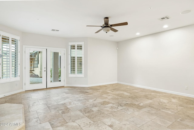 empty room with ceiling fan and french doors