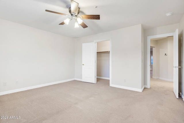 unfurnished bedroom featuring light colored carpet and ceiling fan