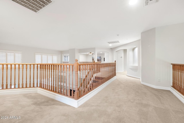 hallway with light colored carpet