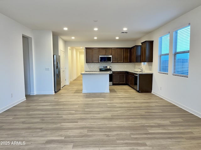 kitchen with recessed lighting, a sink, dark brown cabinetry, and stainless steel appliances