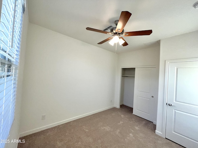 unfurnished bedroom with a ceiling fan, baseboards, light carpet, and a closet