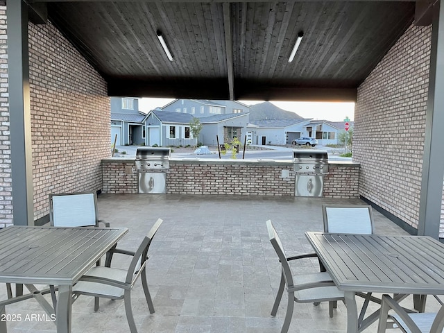 view of patio / terrace featuring a residential view, grilling area, outdoor dining area, and area for grilling
