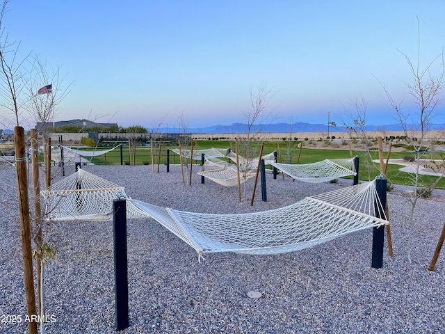 view of property's community featuring fence and a mountain view