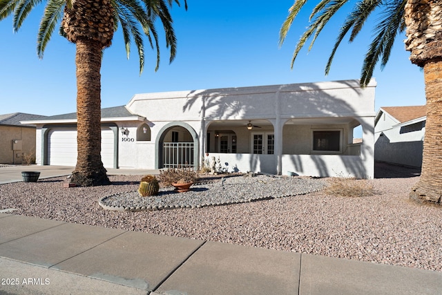 ranch-style house with a garage and ceiling fan