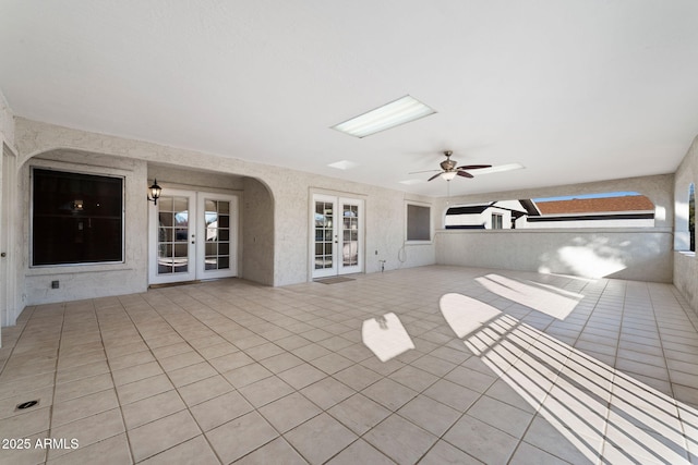 view of patio / terrace featuring ceiling fan and french doors