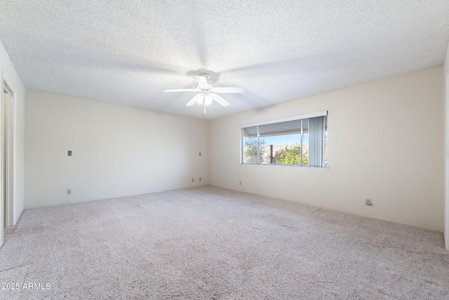 carpeted empty room with ceiling fan and a textured ceiling